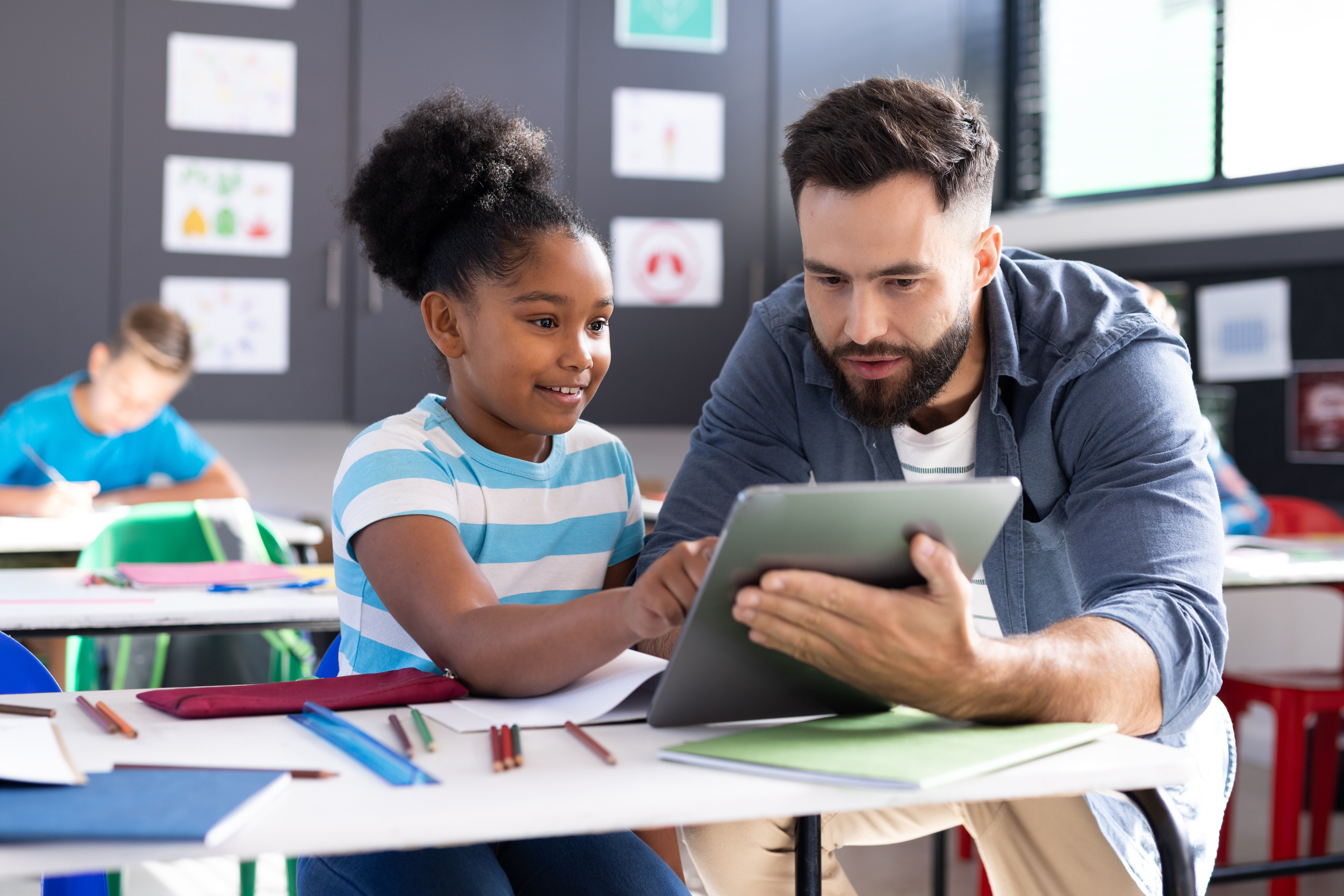 diverse-male-teacher-and-happy-girl-using-tablet-a-2025-04-04-17-33-35-utc