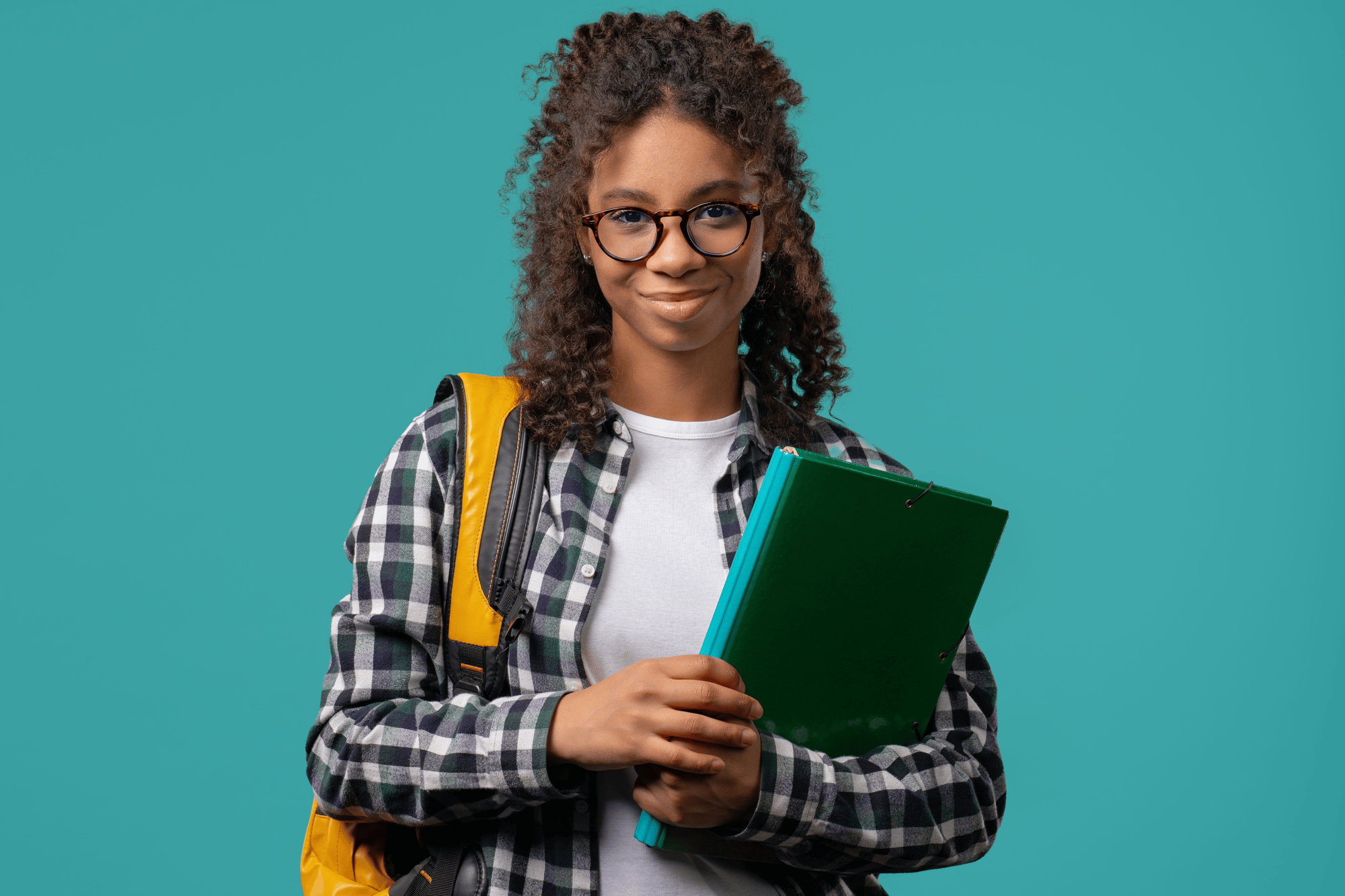 High school student with a backpack and books, smiling
